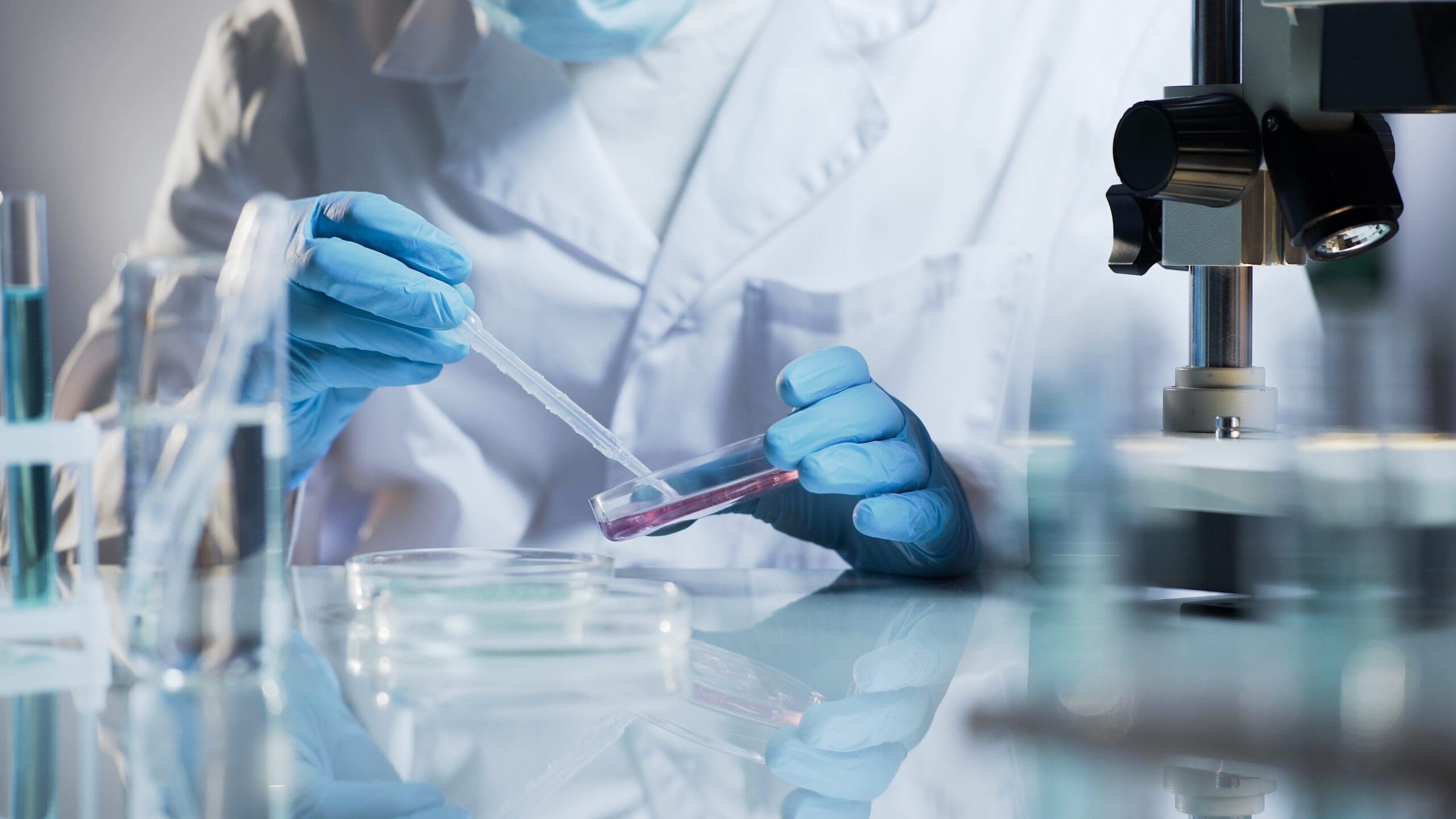 Person wearing gloves working in medical lab