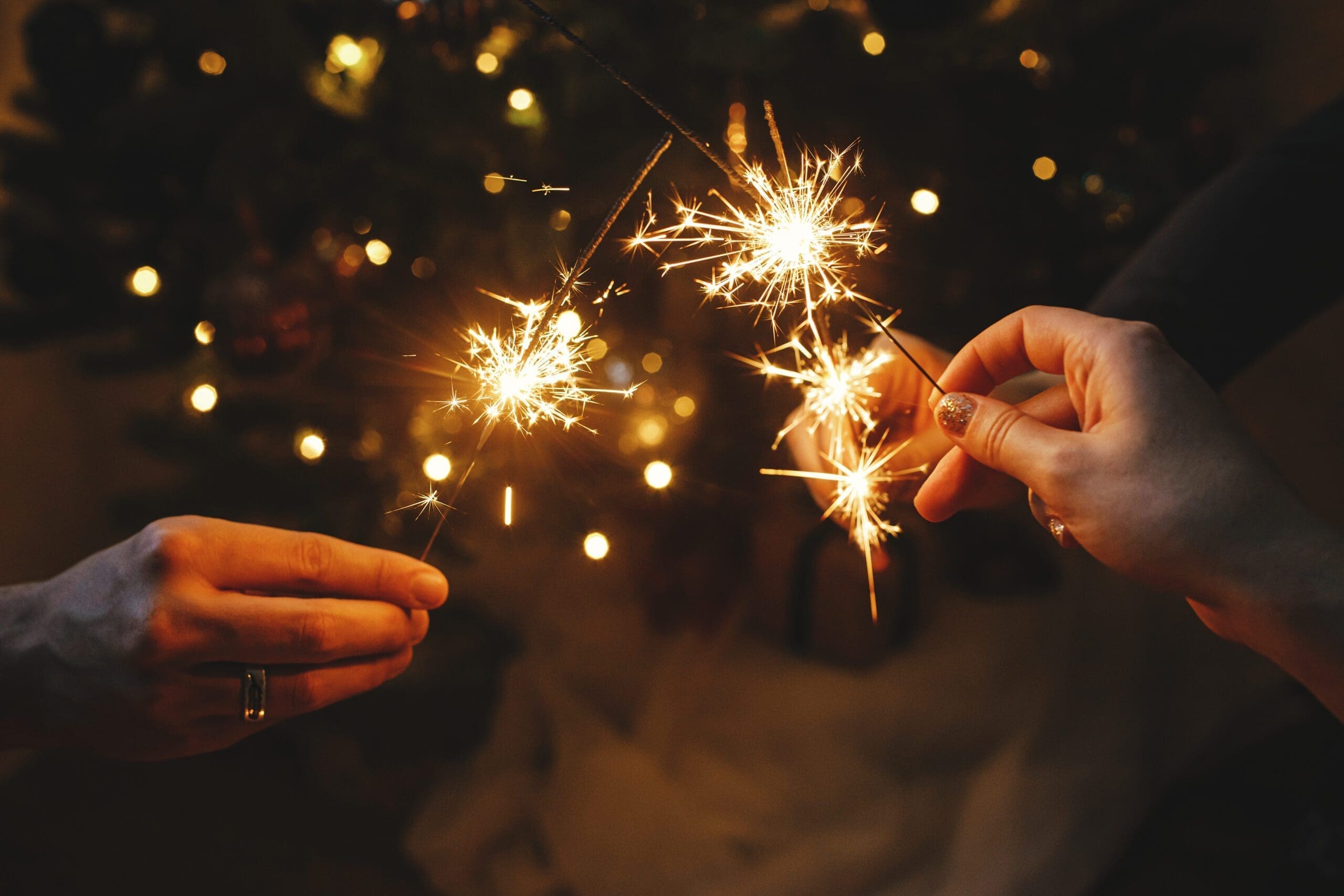 Three people holding sparklers